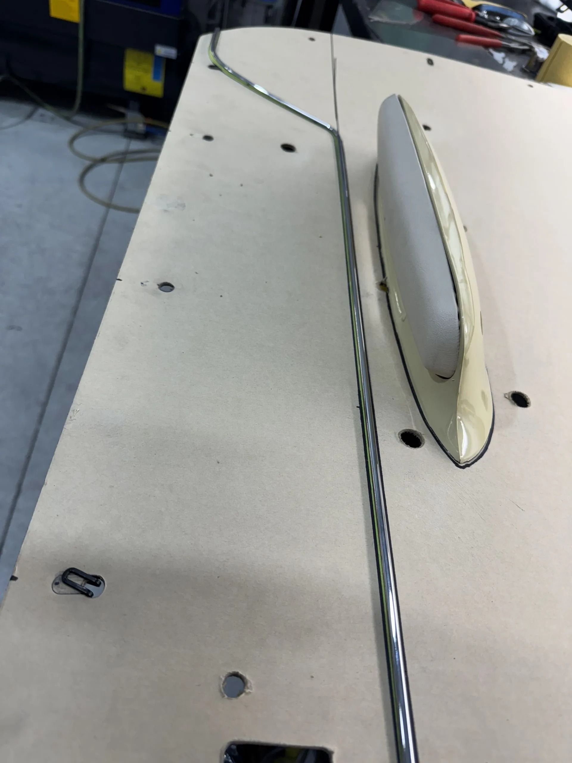 A white antenna is sitting on top of a wooden table