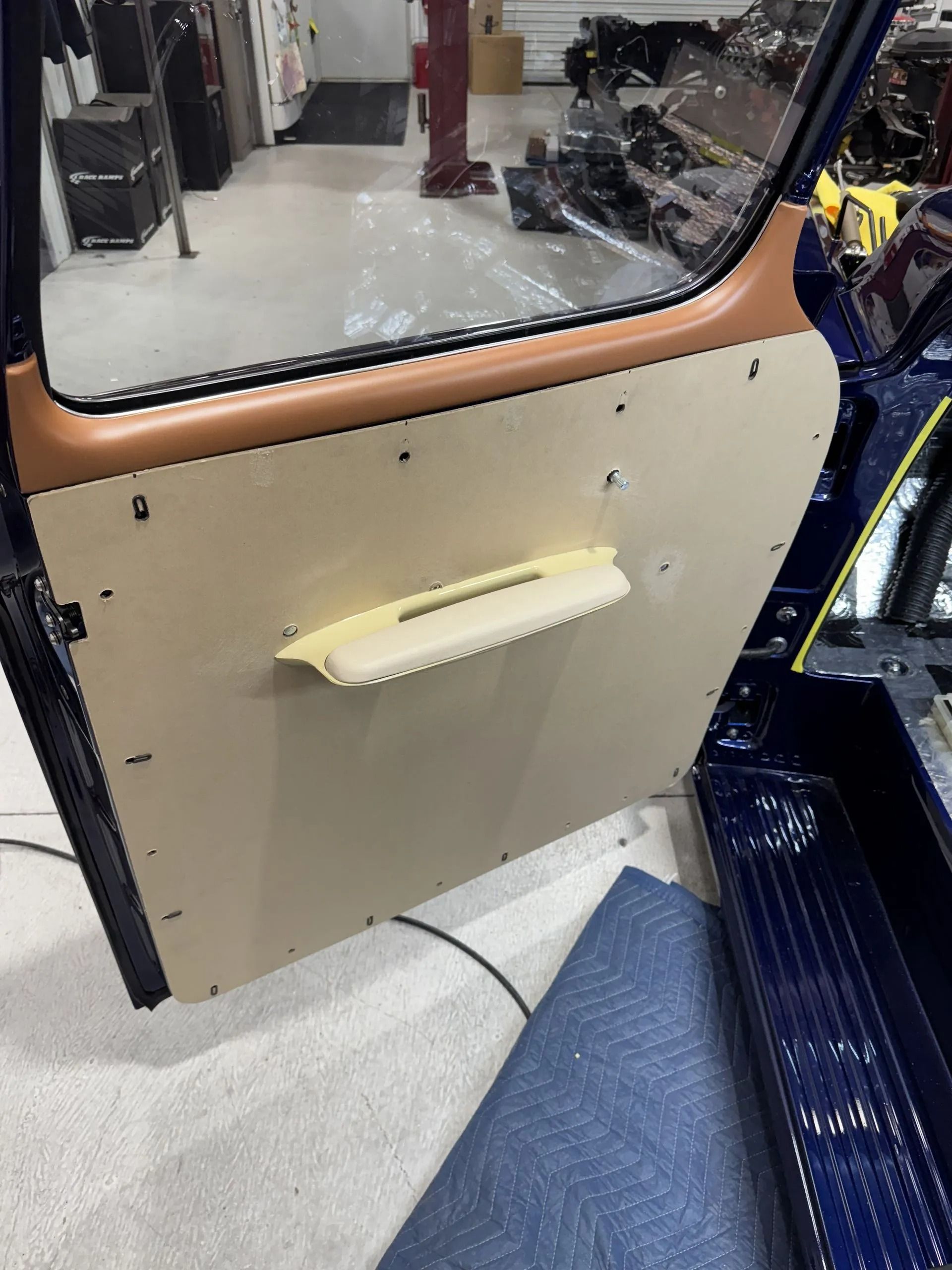 A close up of a car door with a handle on it.