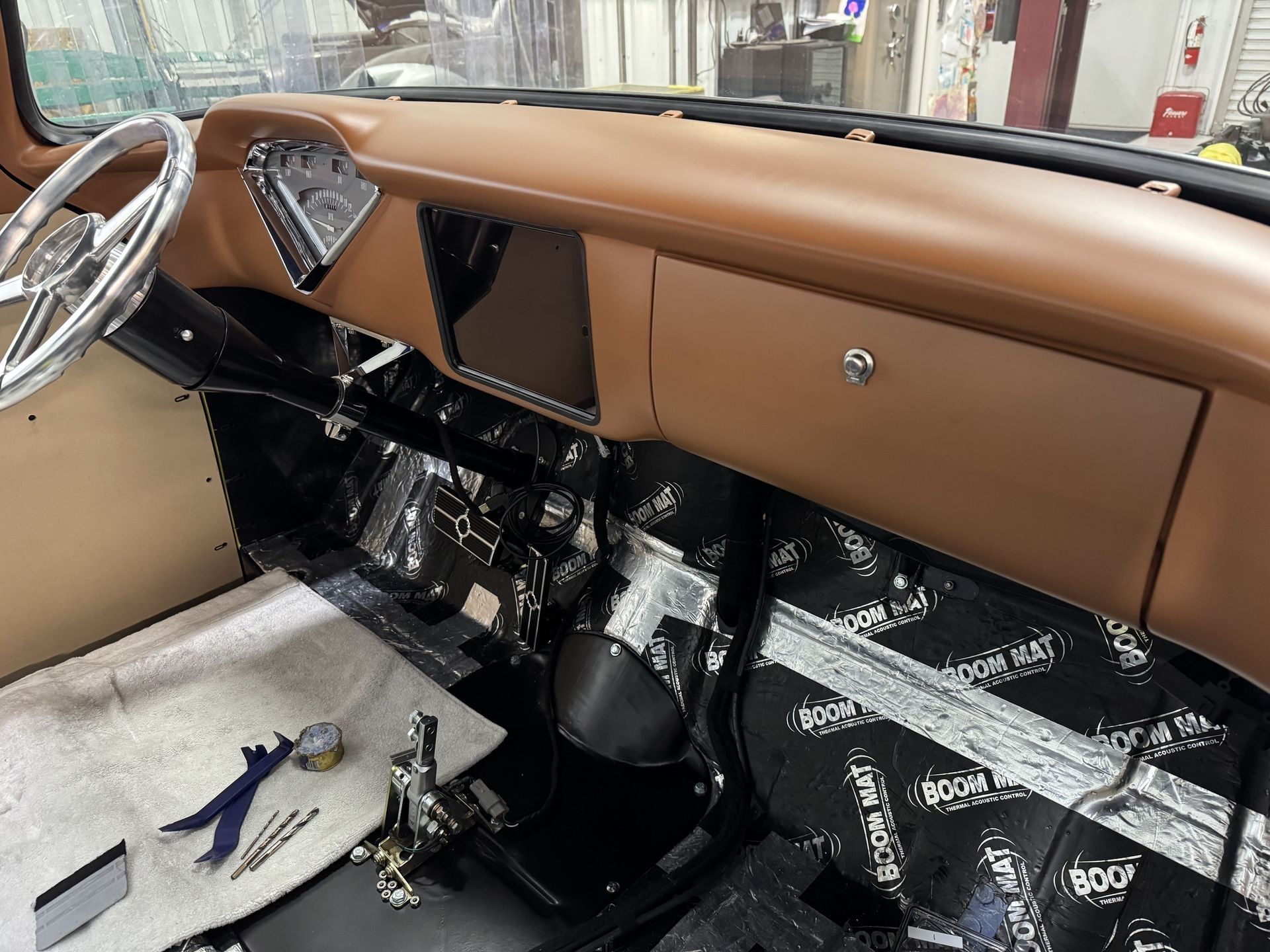 The interior of a car with a steering wheel and dashboard