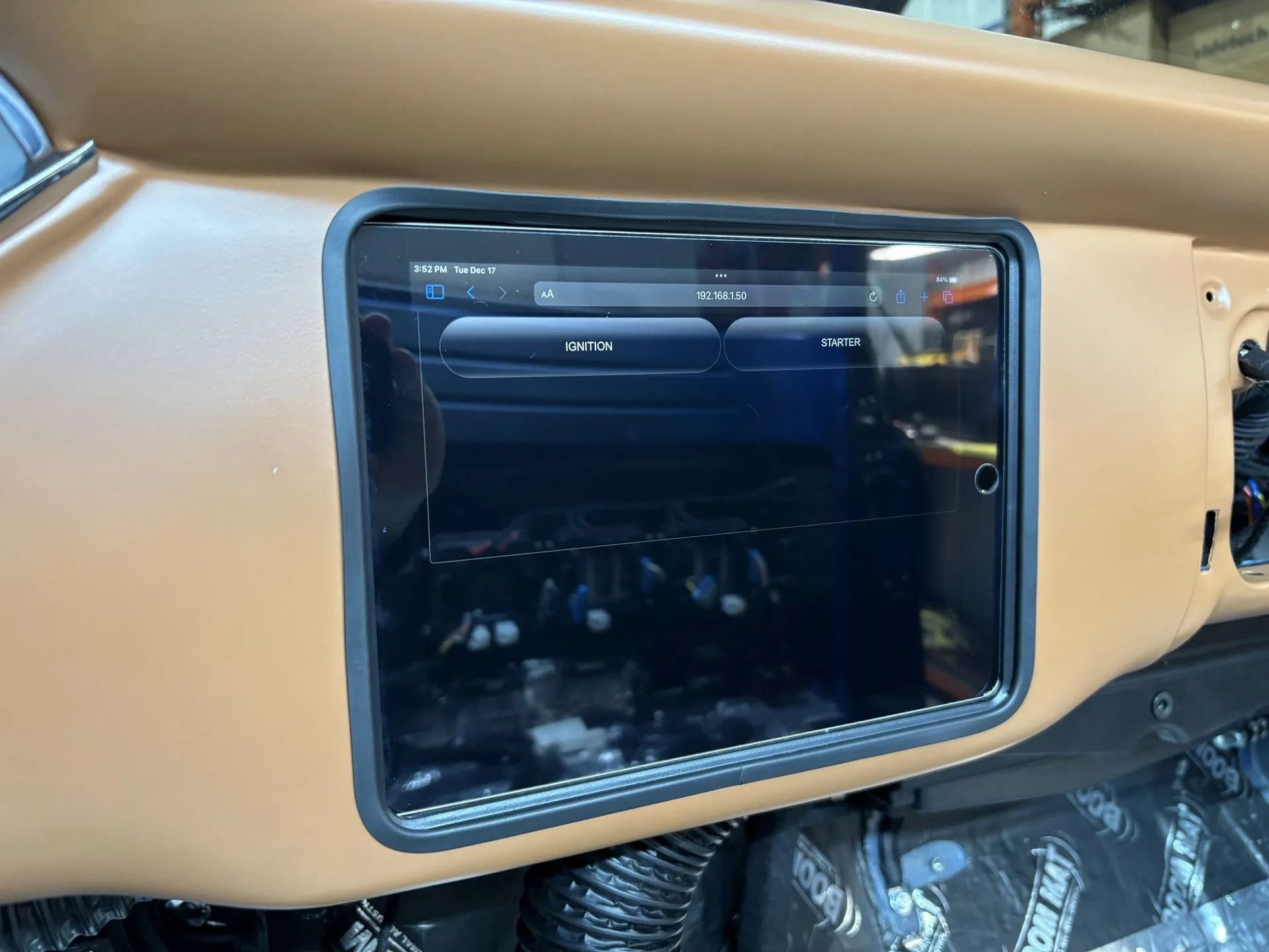 The dashboard of a car with a tablet in it