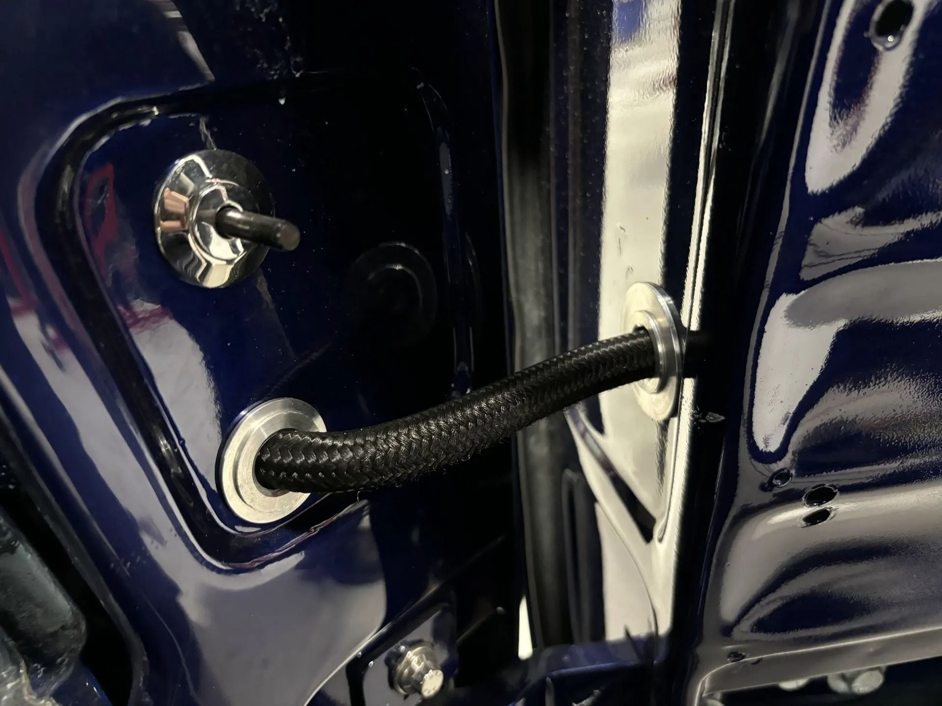 A close up of a door with a hose attached to it