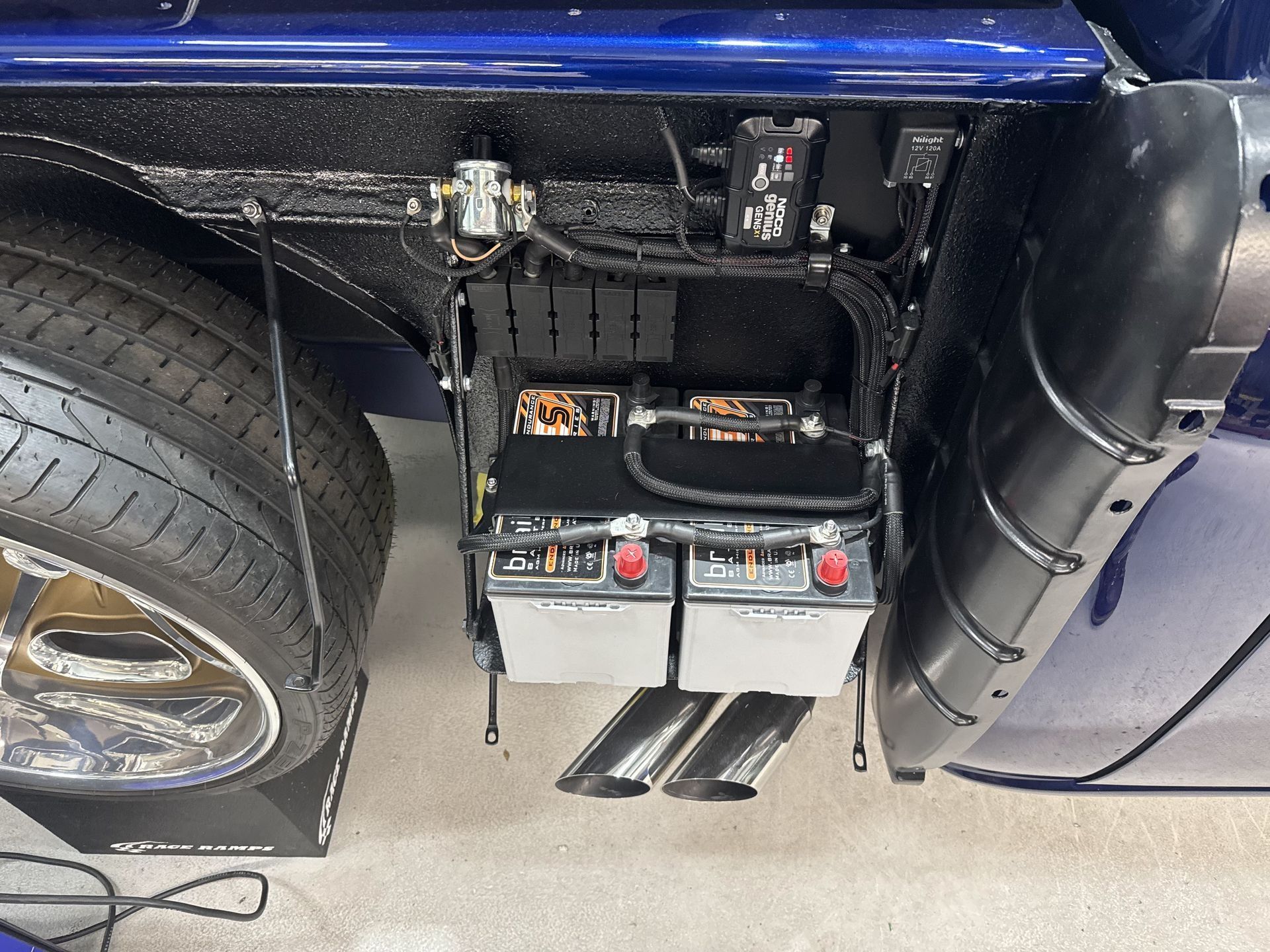 A blue car with two batteries attached to it