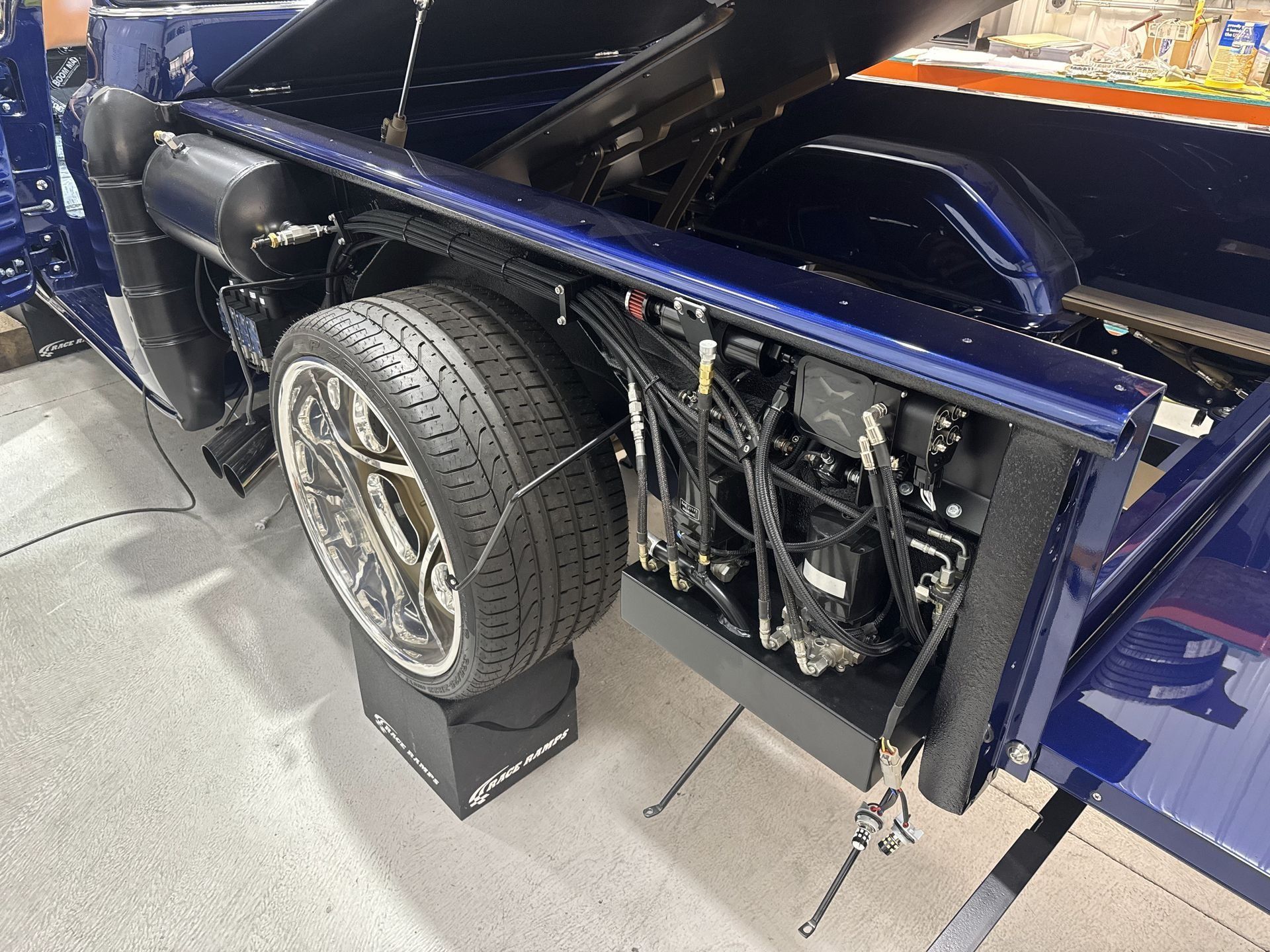 A close up of a car with a tire on a ramp.