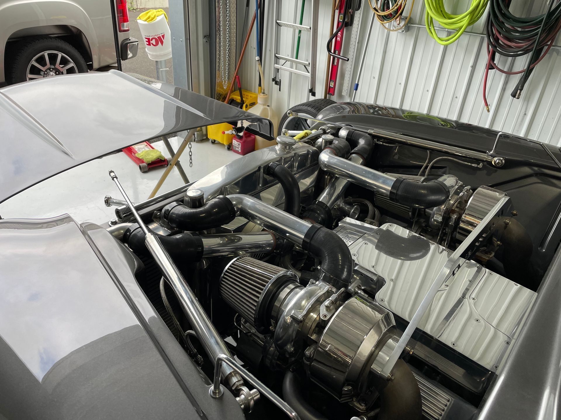 The hood of a car is open and the engine is visible