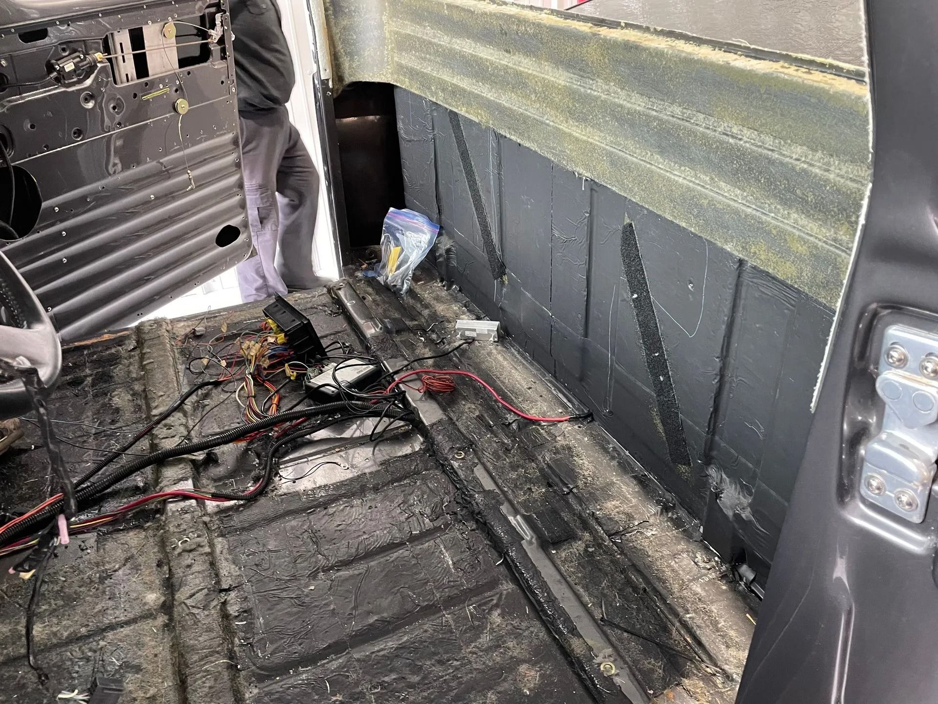 A man is working on the back of a van.