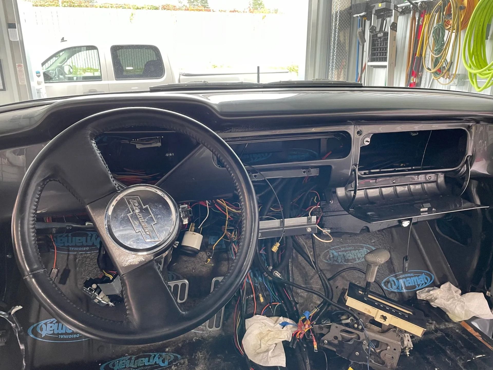 The steering wheel and dashboard of a car are being removed.