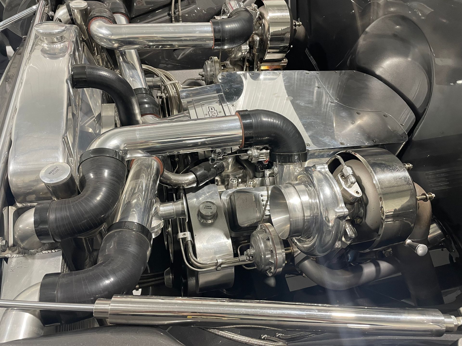 A close up of a car engine with a turbocharger.