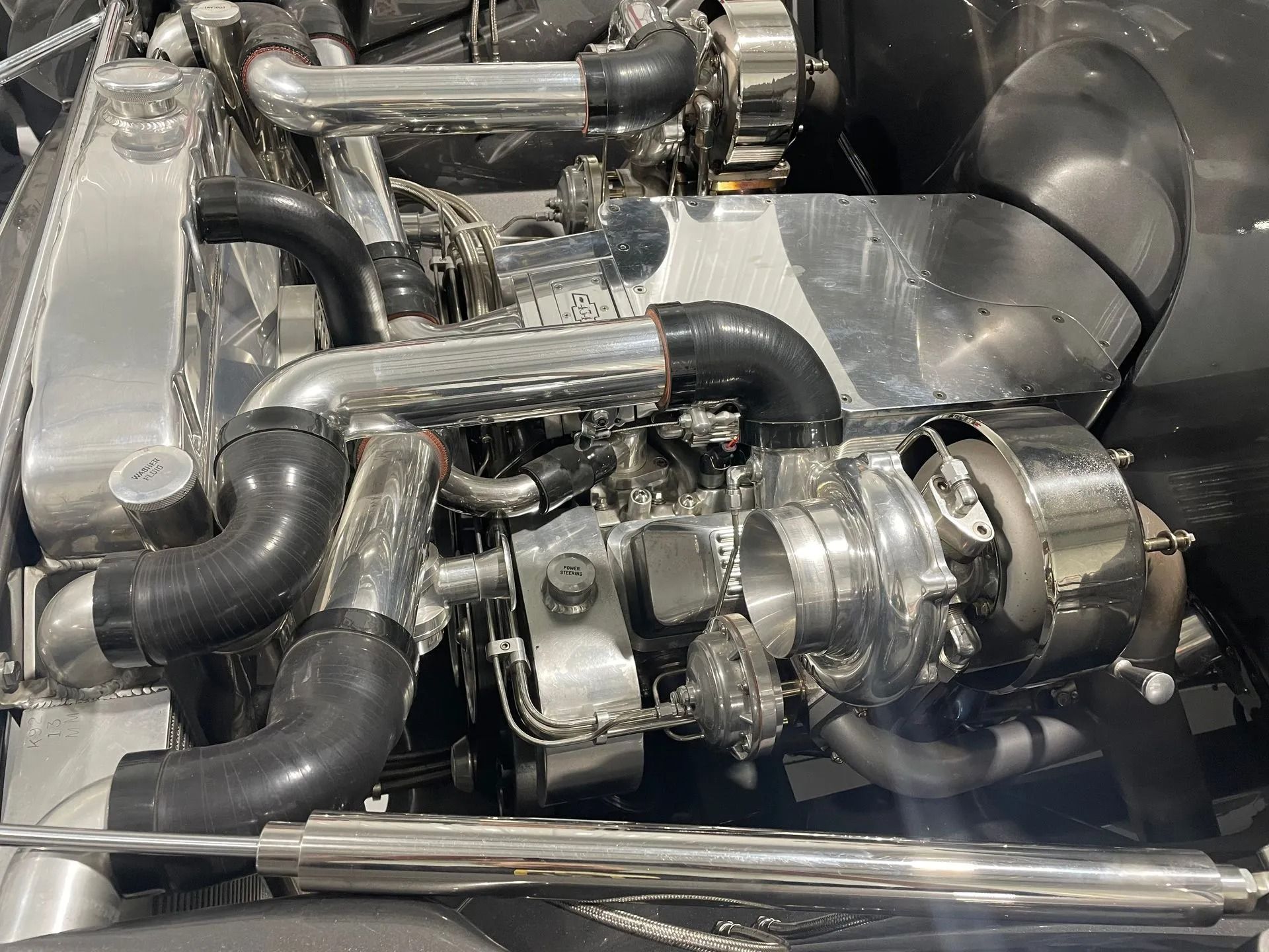 A close up of a car engine with a turbocharger.