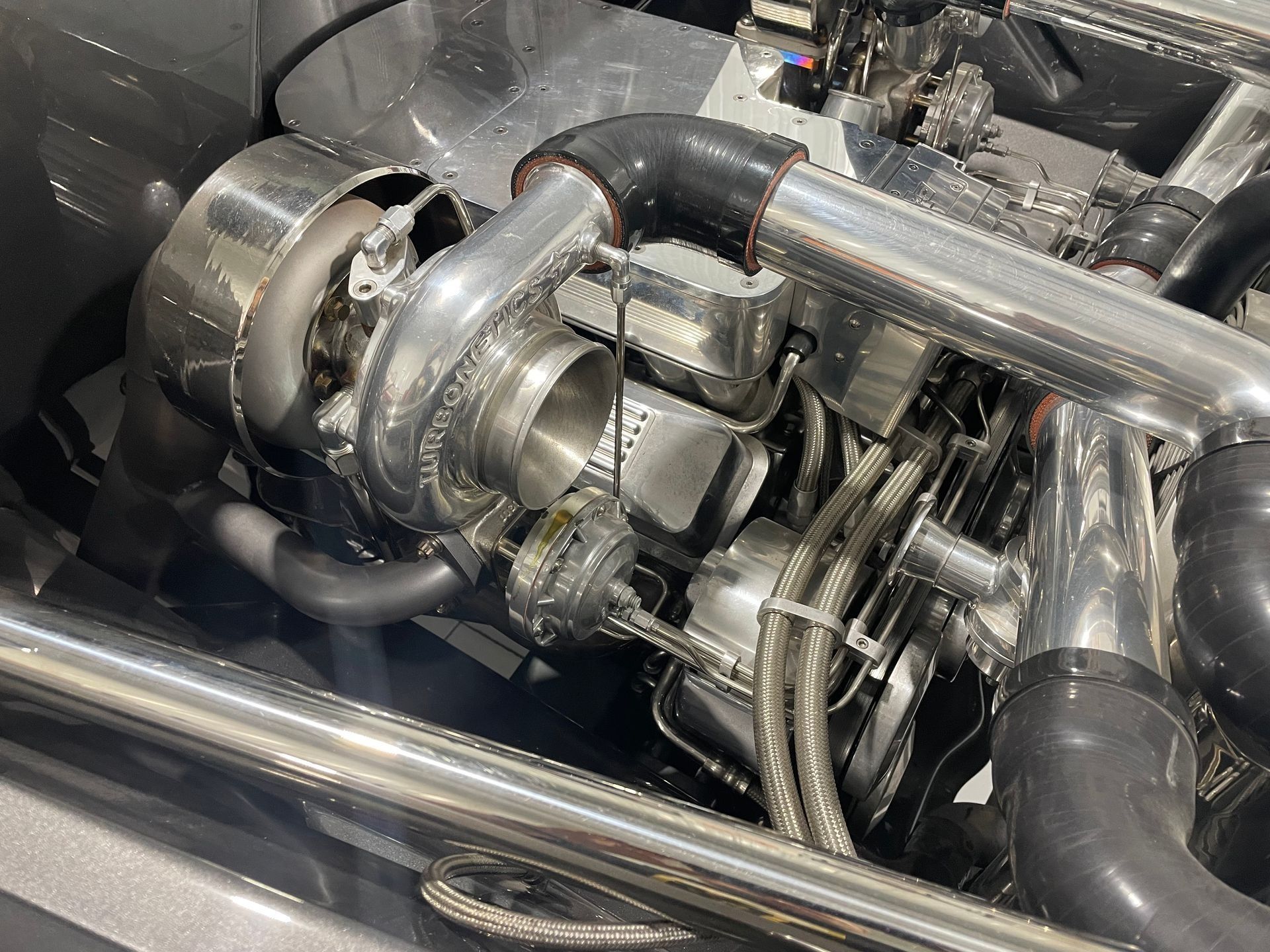 A close up of a turbocharger on a car engine.