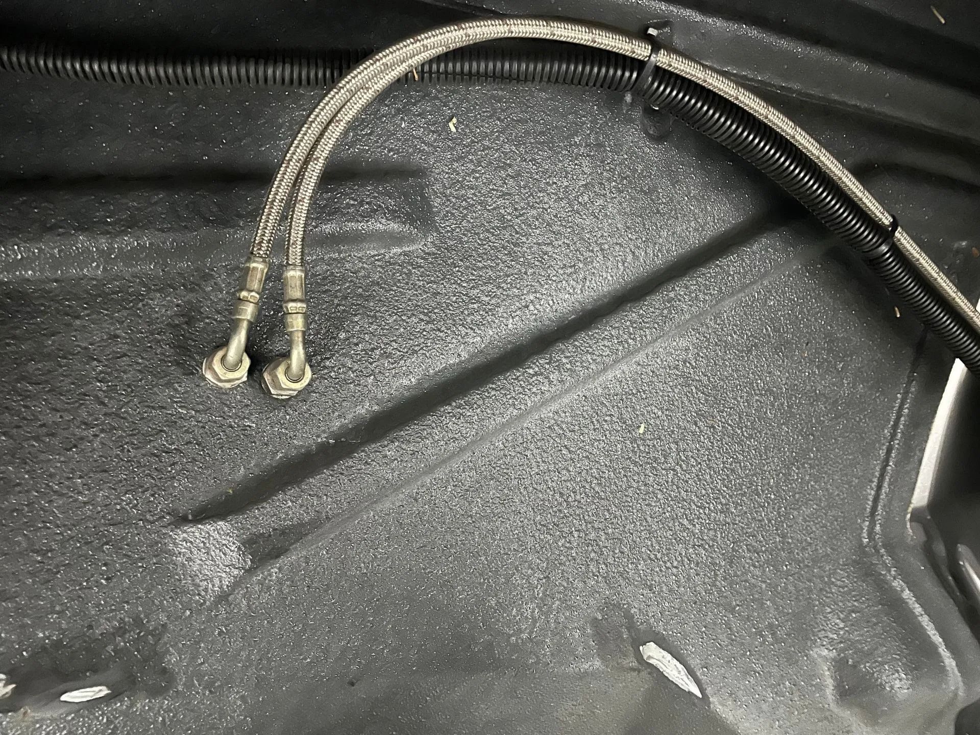 A close up of two hose connected to a metal surface