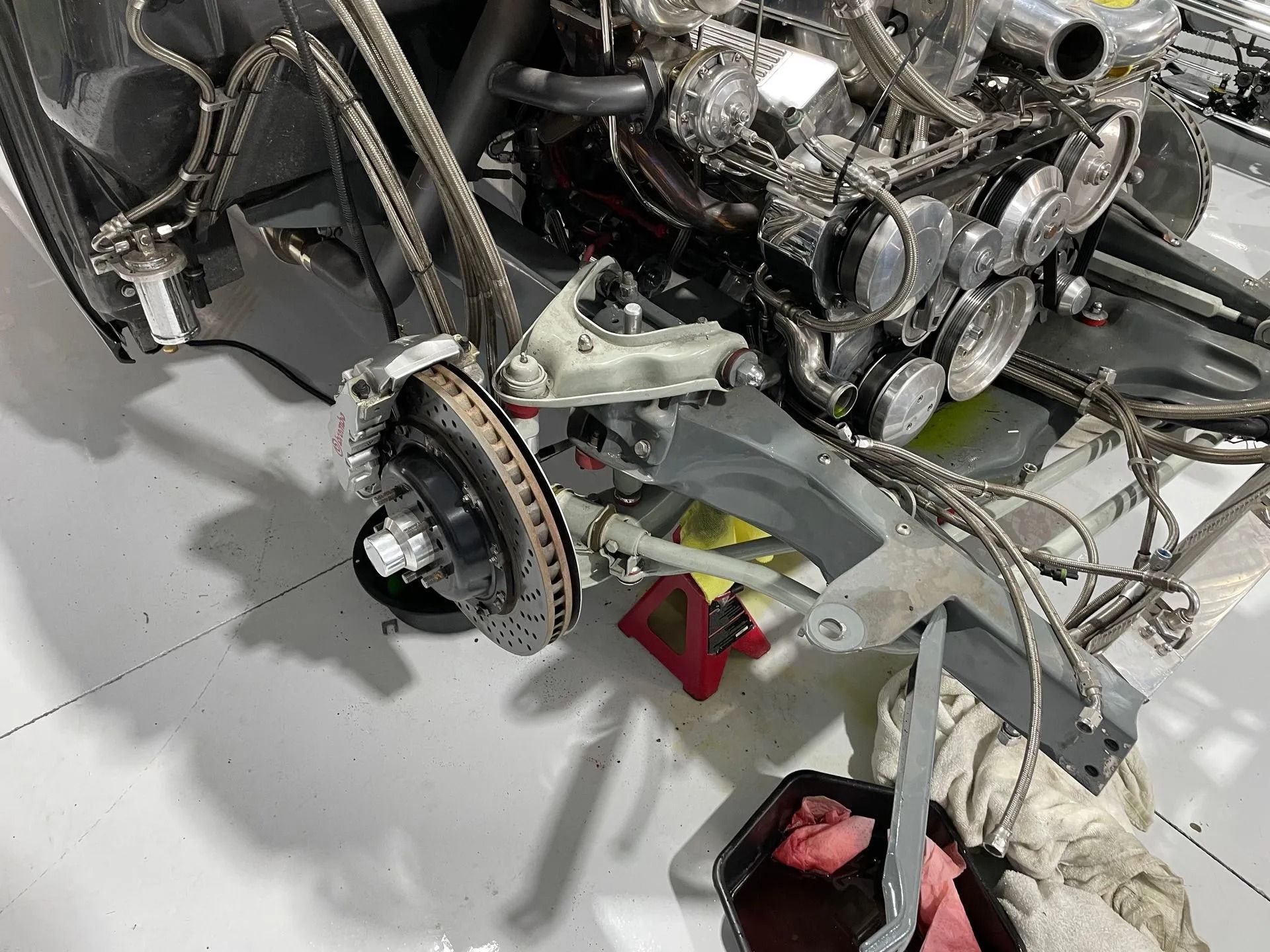 A car engine is being worked on in a garage.