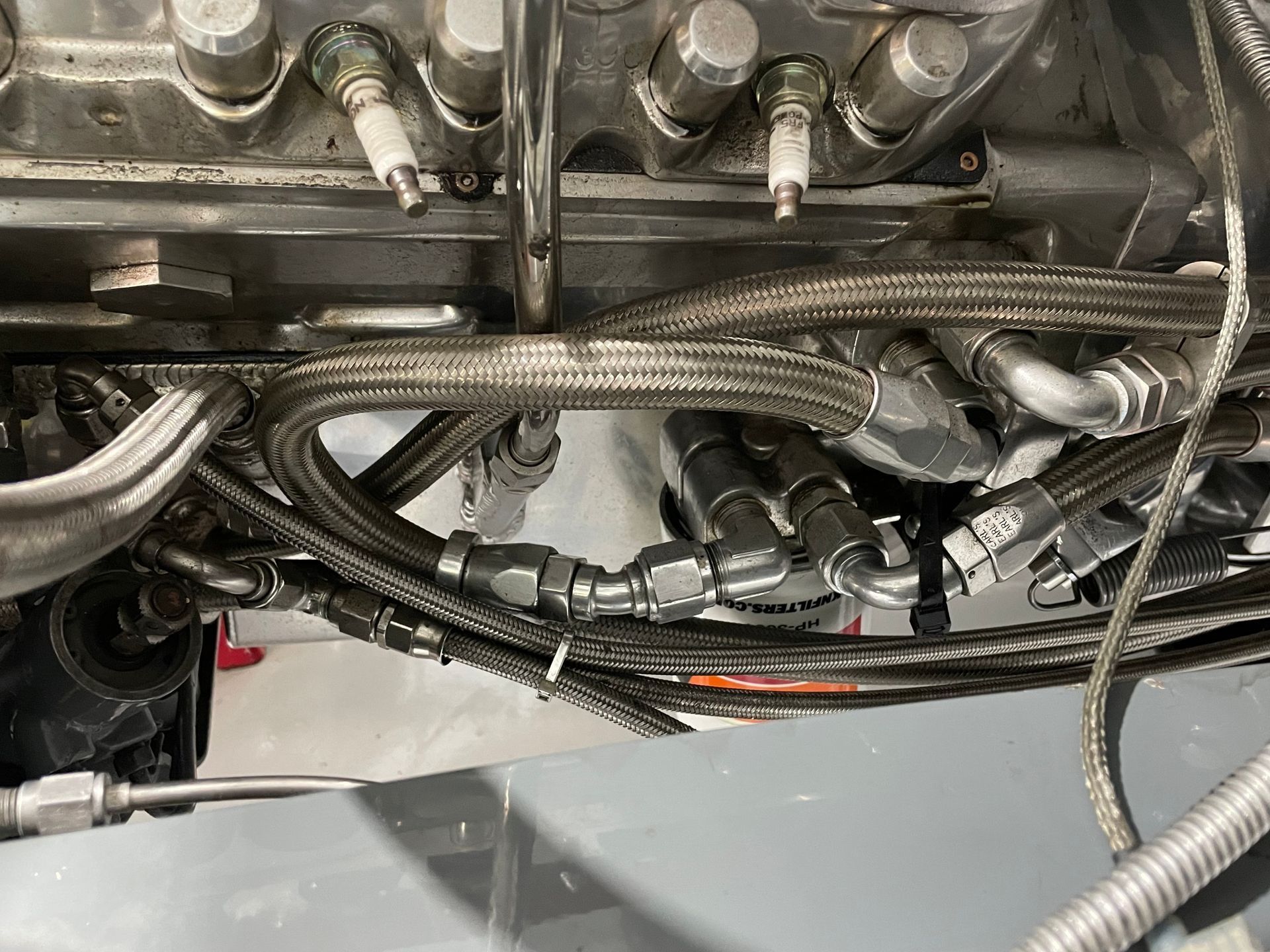 A close up of a car engine with hose attached to it