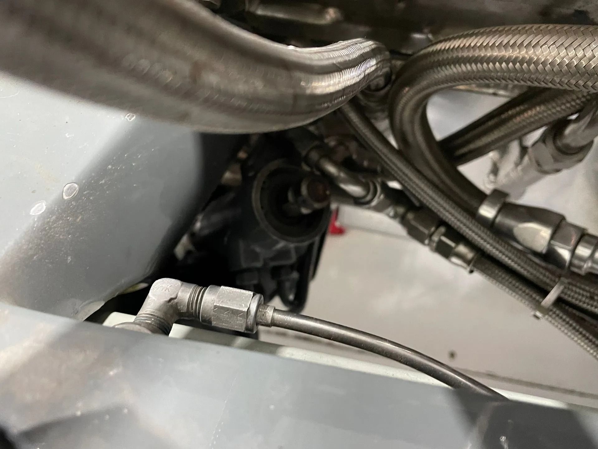 A close up of a hose on the side of a car.