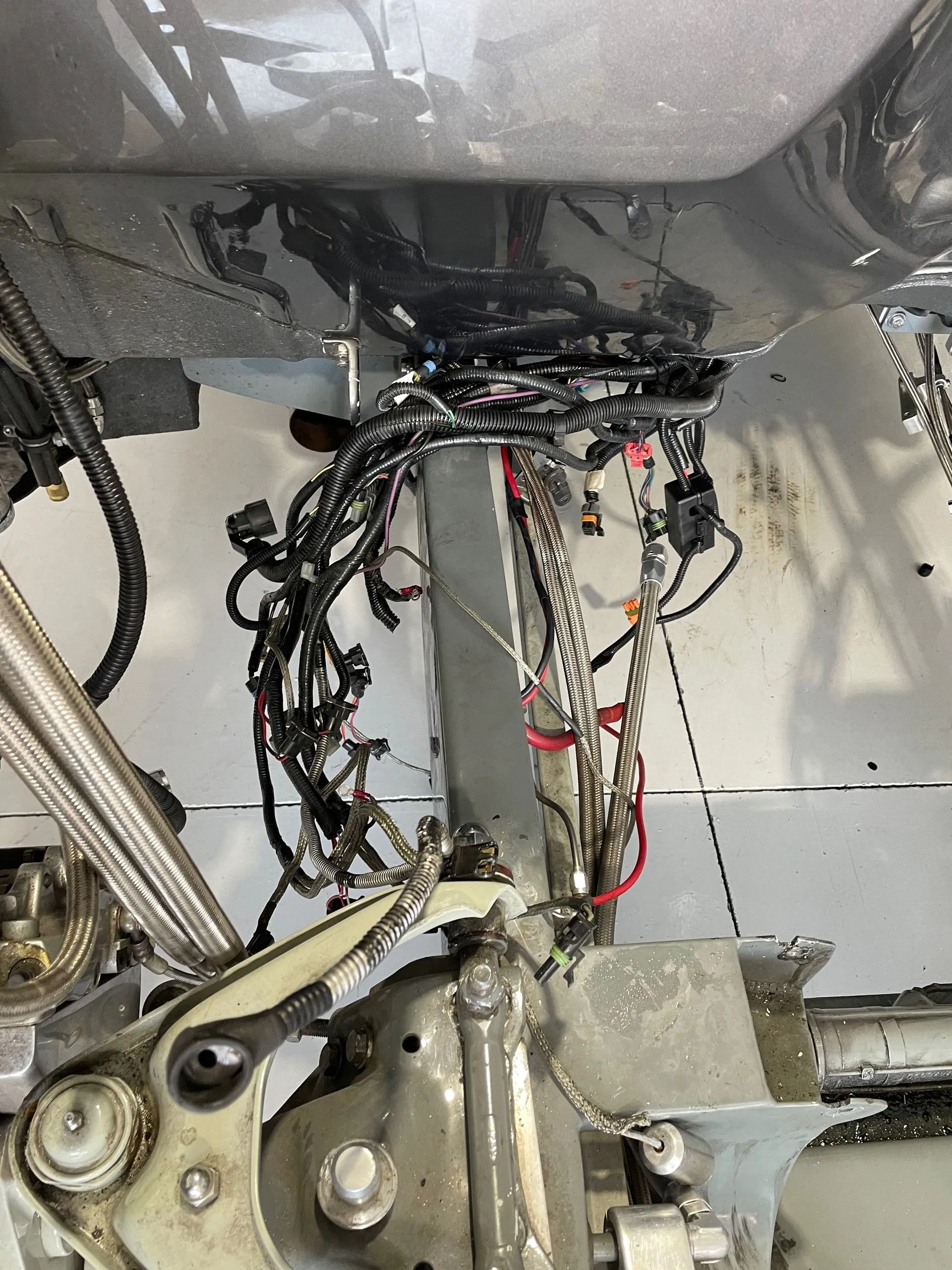 A close up of a motorcycle with a lot of wires coming out of it.