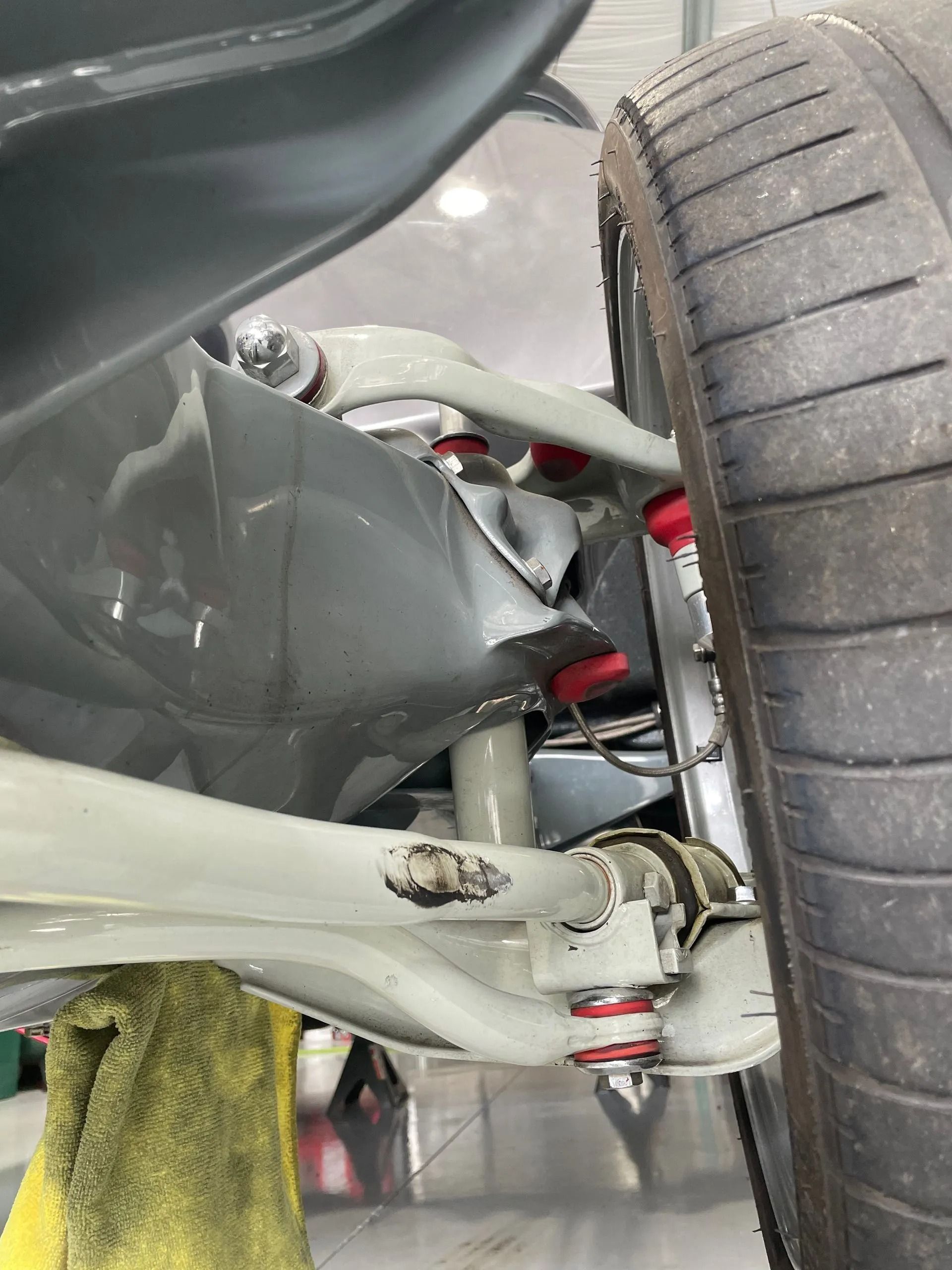 A close up of a car 's suspension and tire.