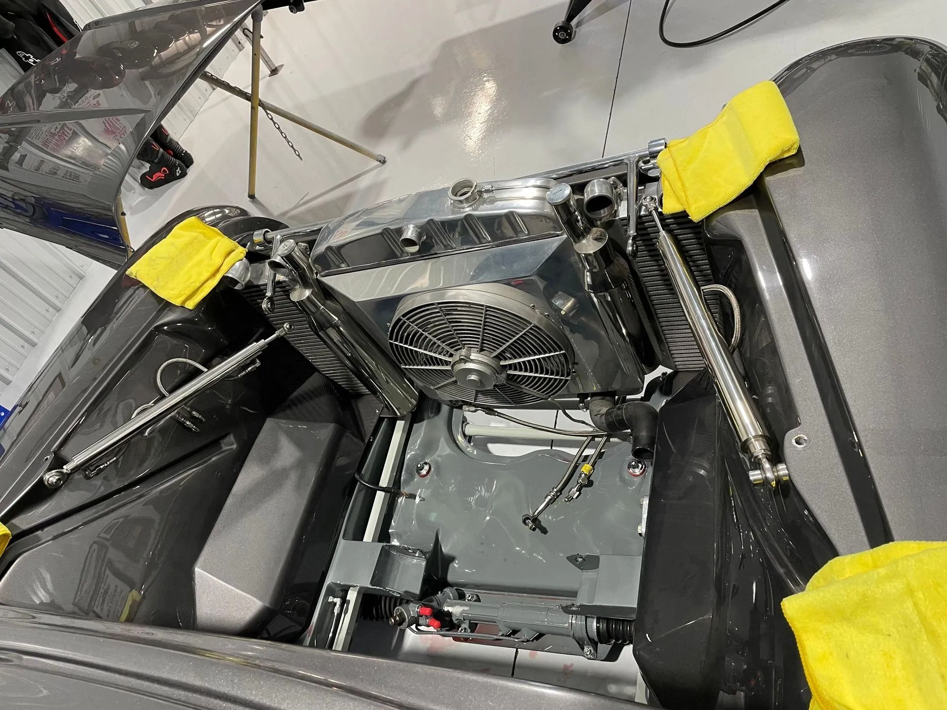 A close up of a car engine with yellow cloths on it
