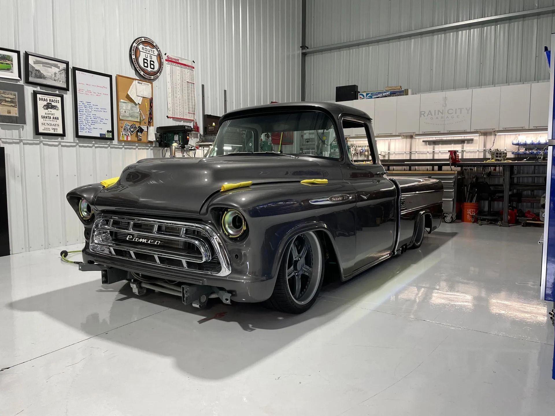 A gray pickup truck is parked in a garage.