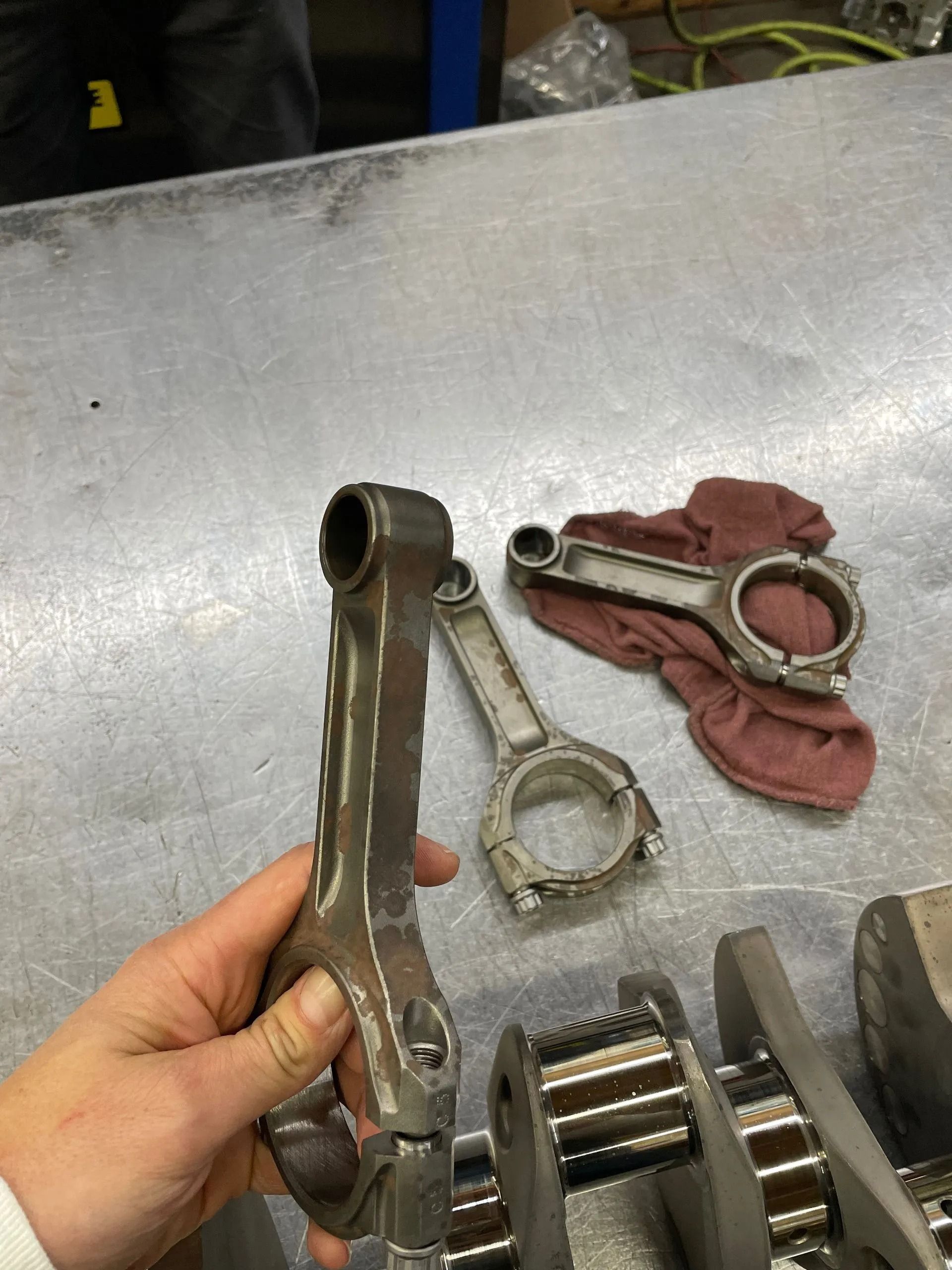 A person is holding a piece of metal in their hand