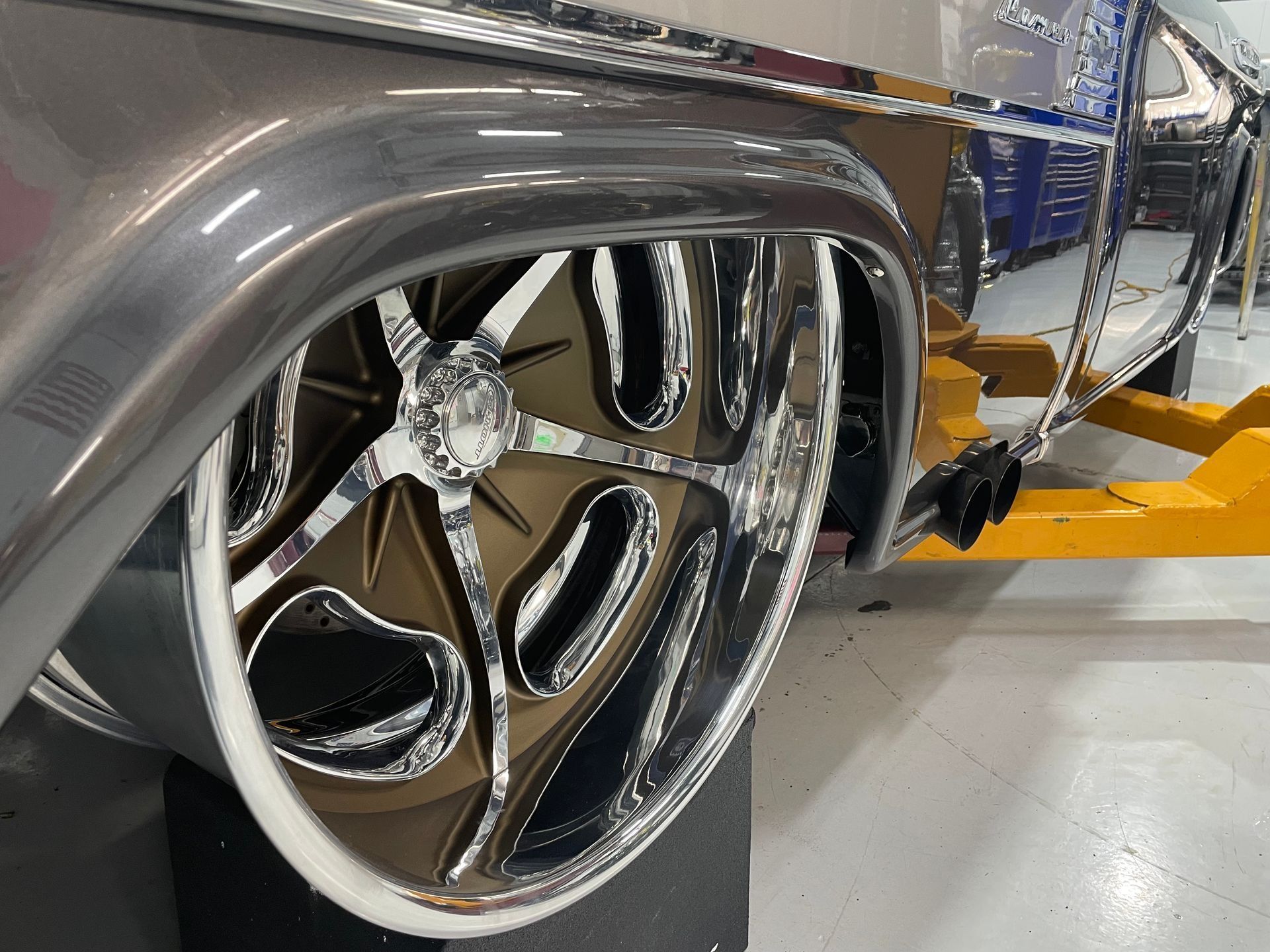 A close up of a car wheel in a garage