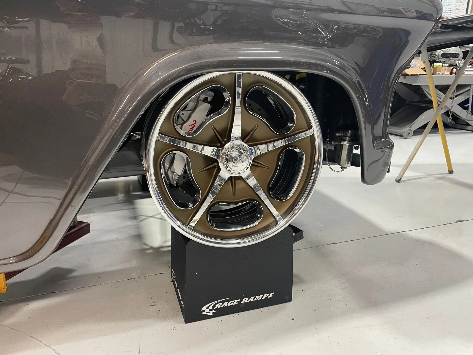 A car wheel is sitting on top of a black box.