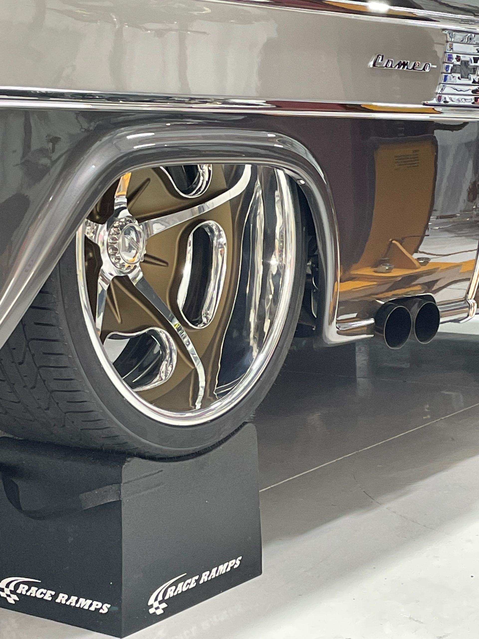 A car is parked on a ramp that says rack ramps