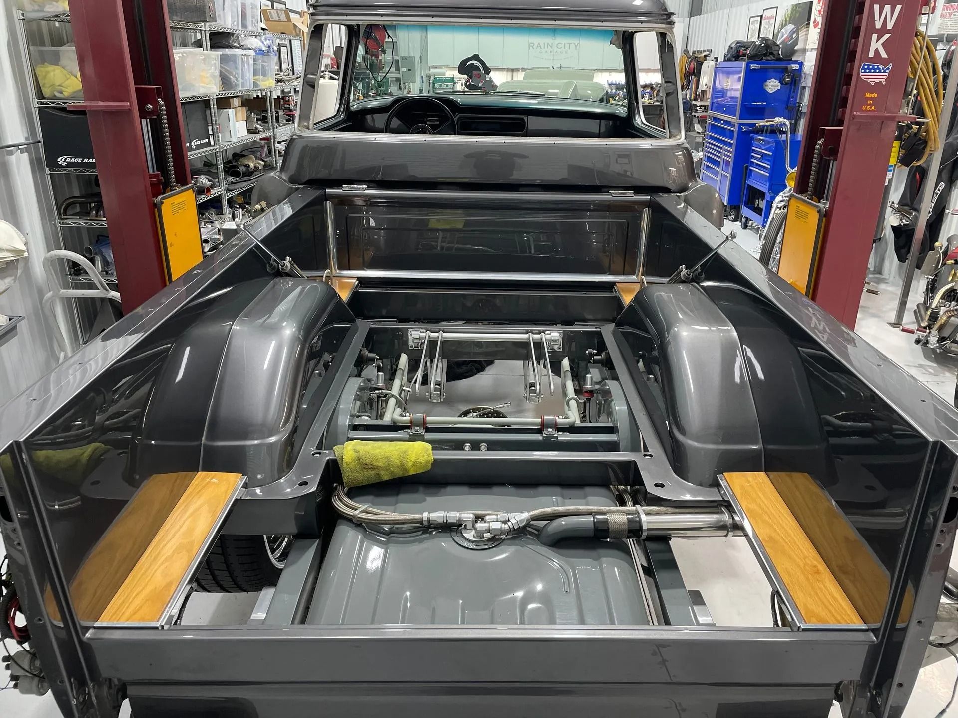 A pickup truck is being built in a garage.