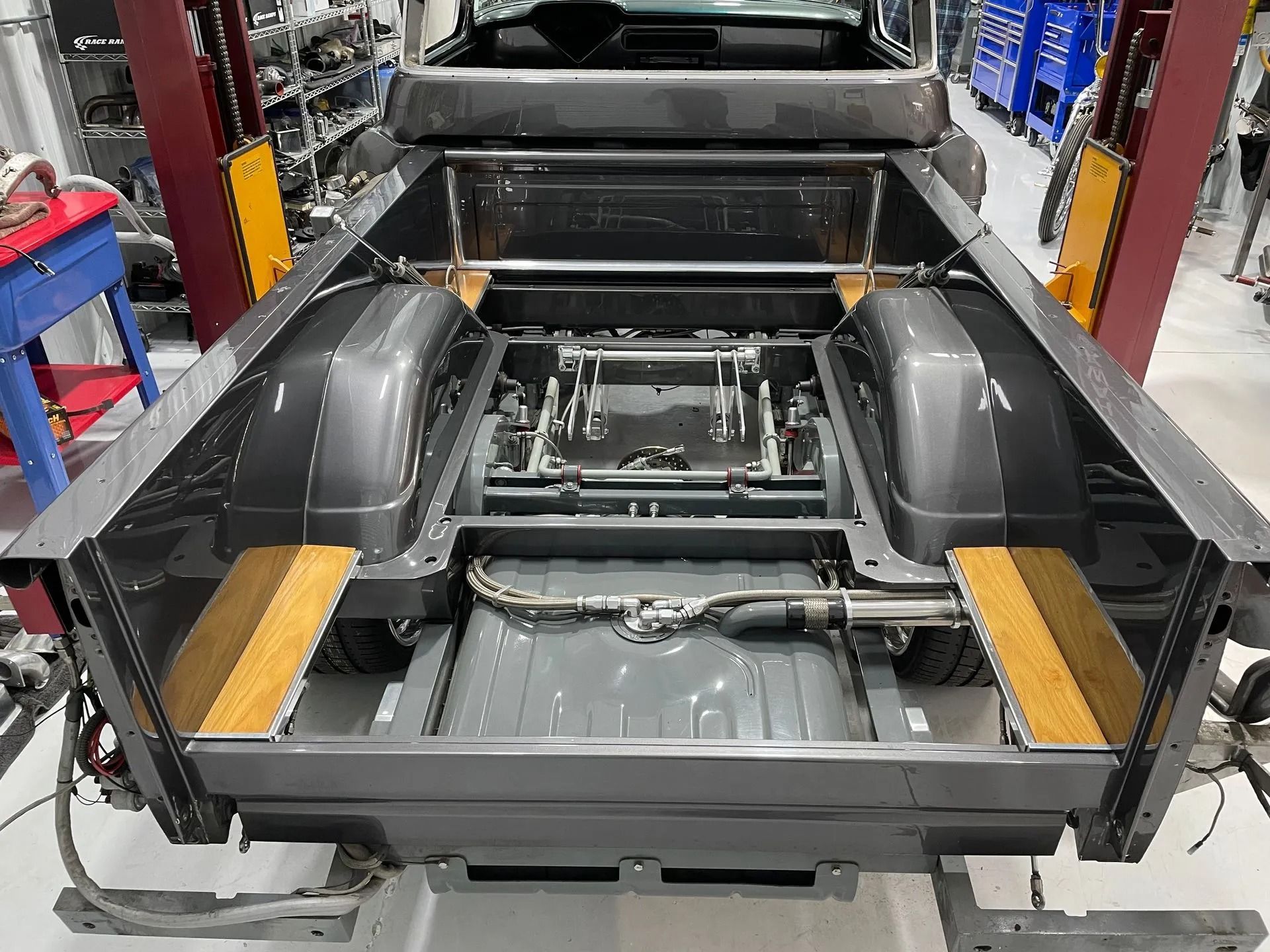 The back of a truck is being built in a garage.