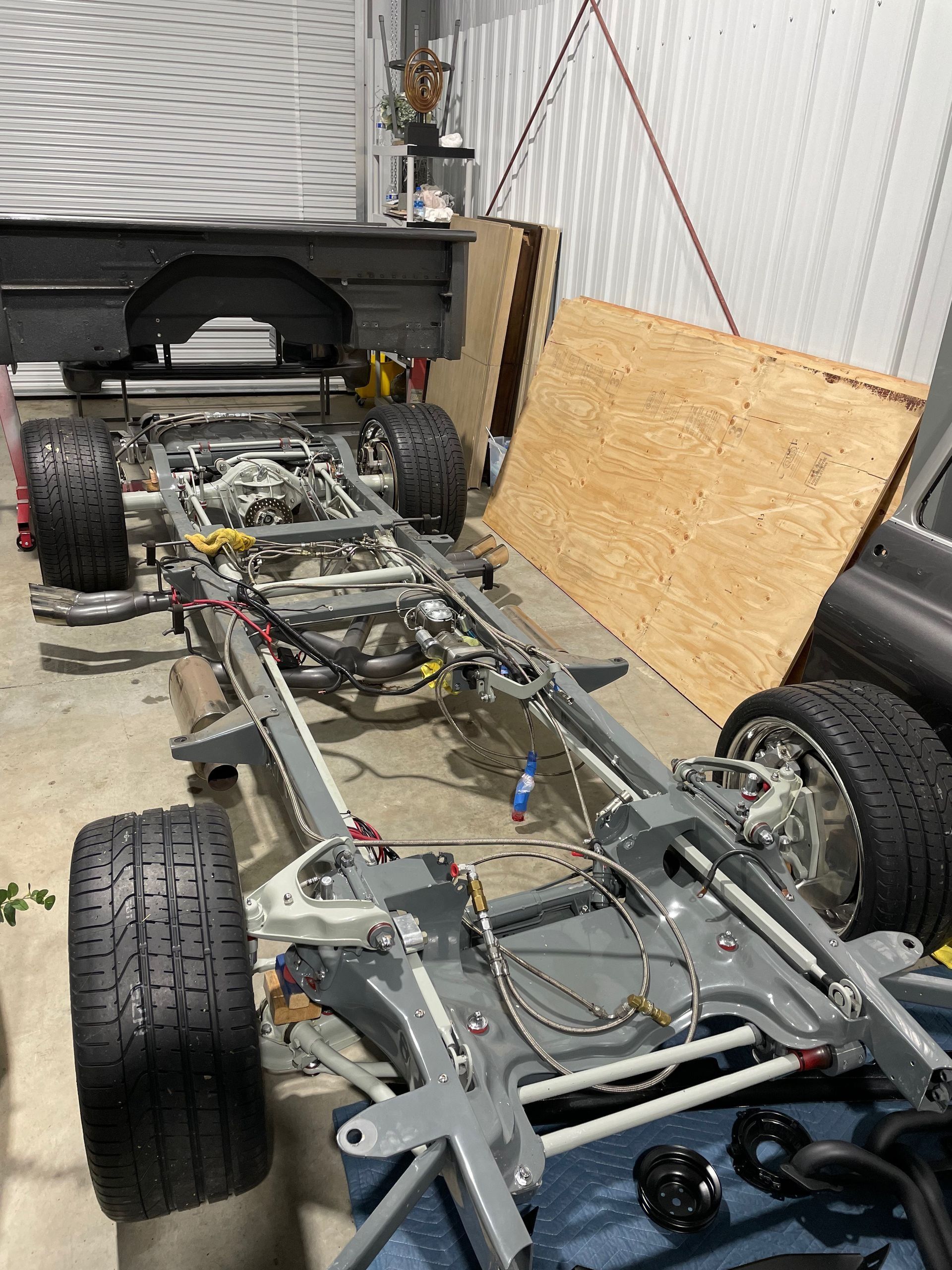 A truck chassis is being built in a garage.