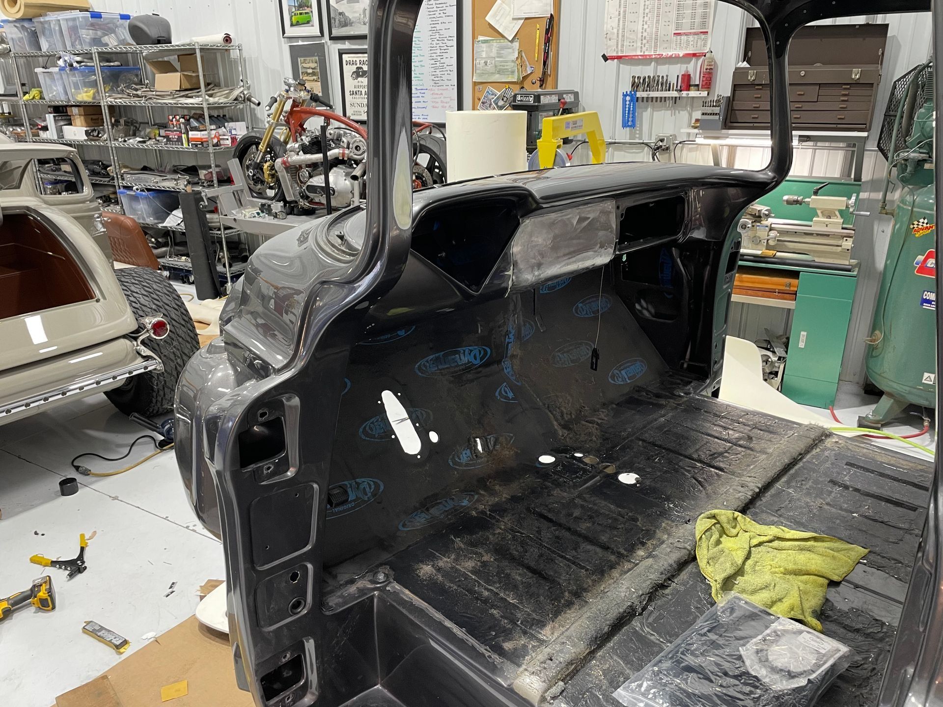 A car is being worked on in a garage.