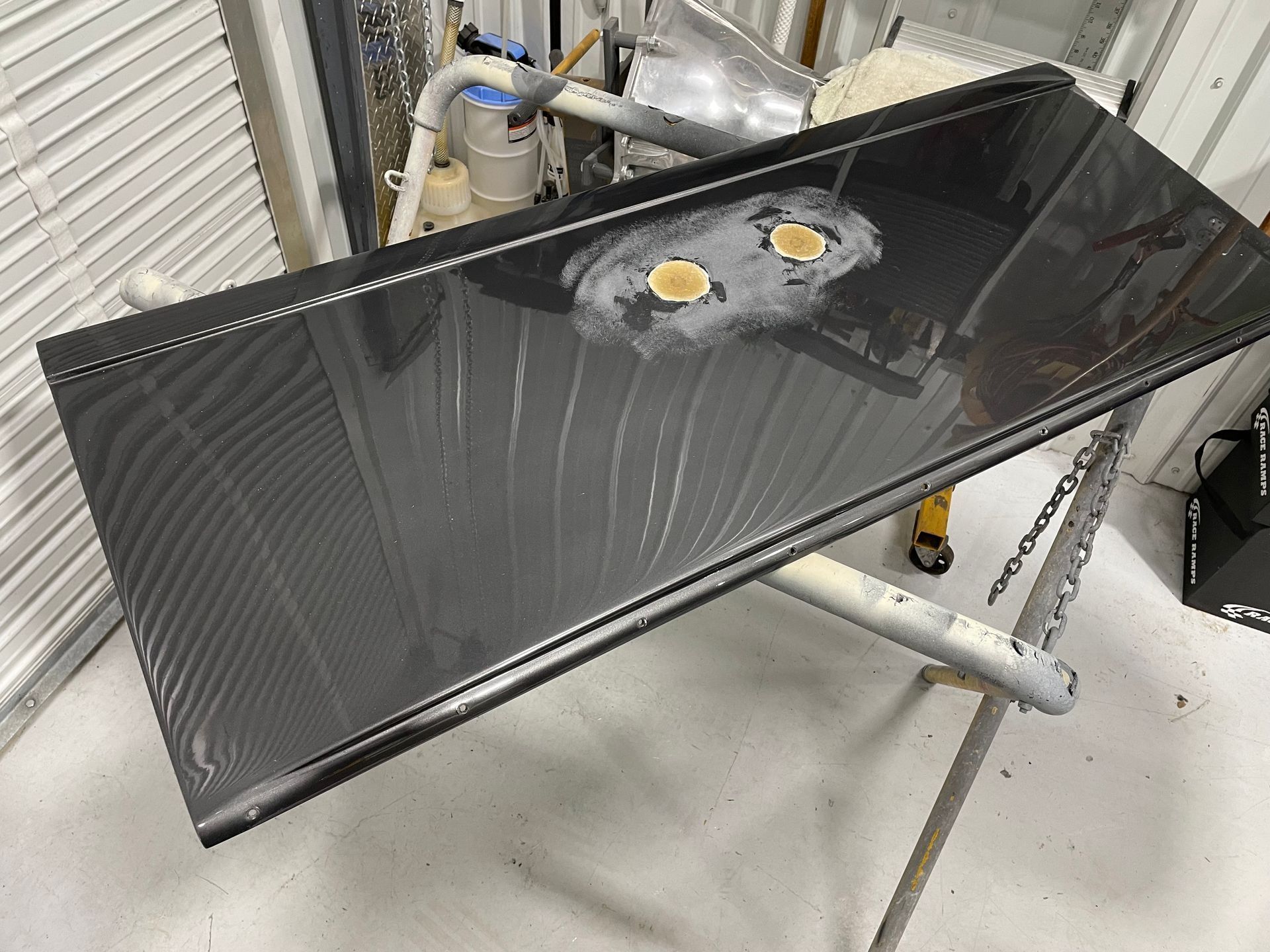 A black piece of metal is sitting on top of a metal stand.