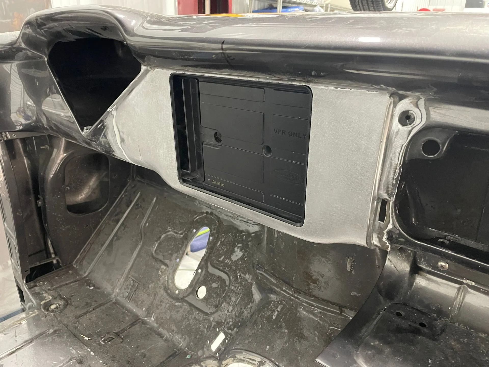 The dashboard of a car is being remodeled.