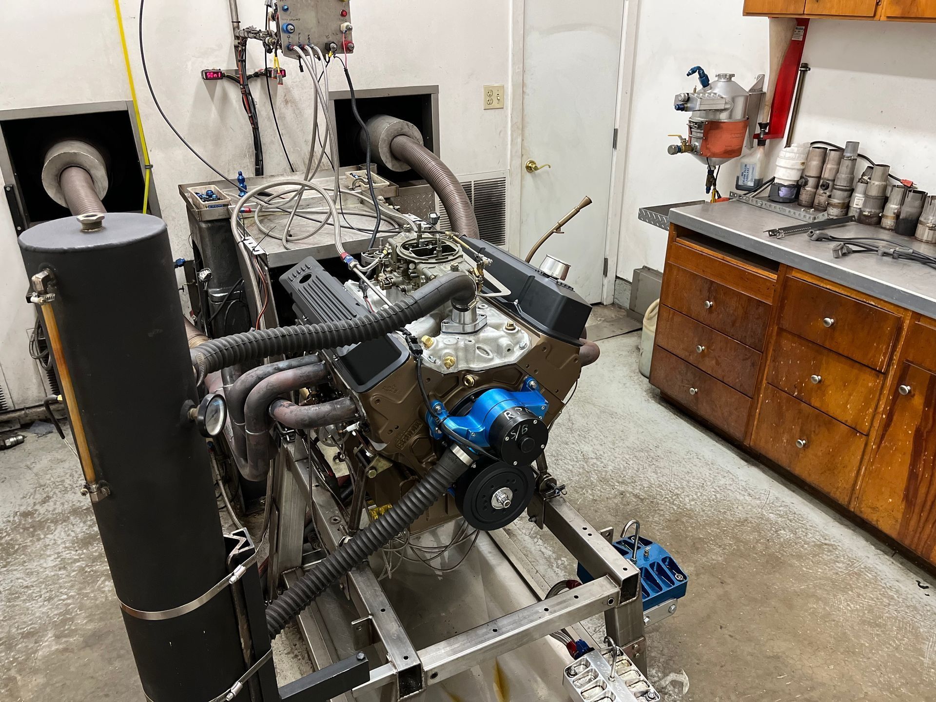 A large engine is being tested in a garage