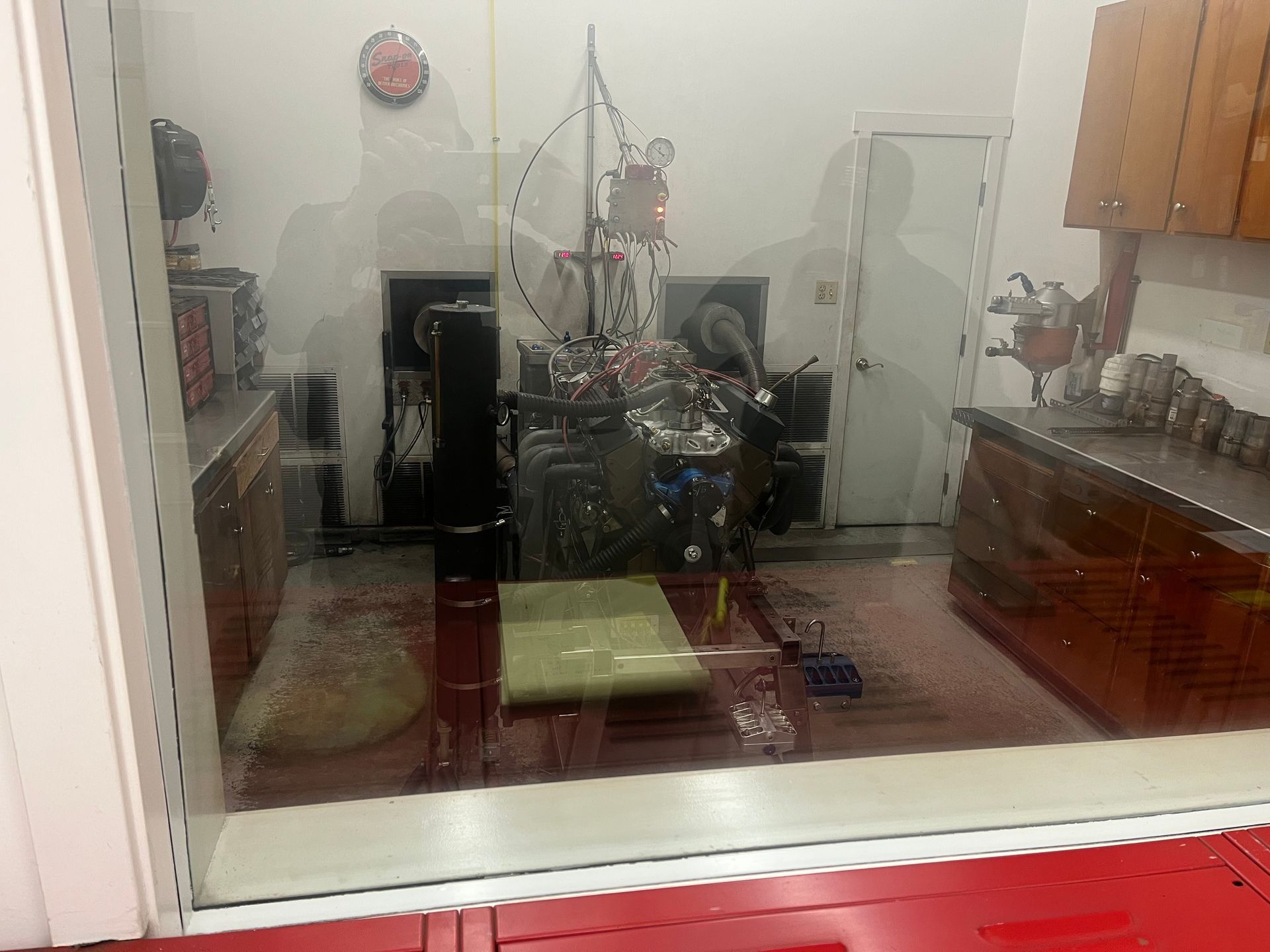 A room with a reflection of a person in the window.