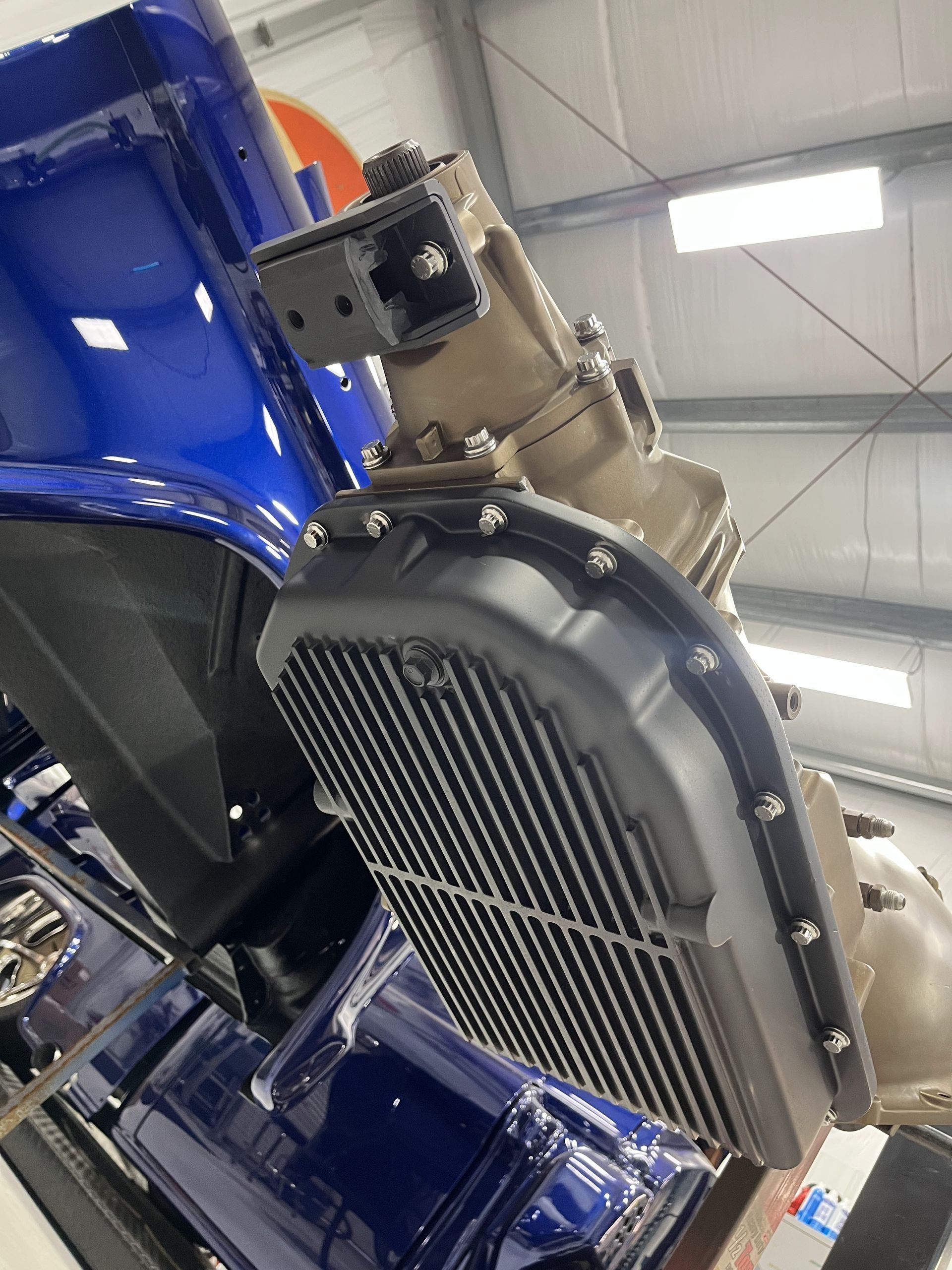 A close up of a car engine in a garage.