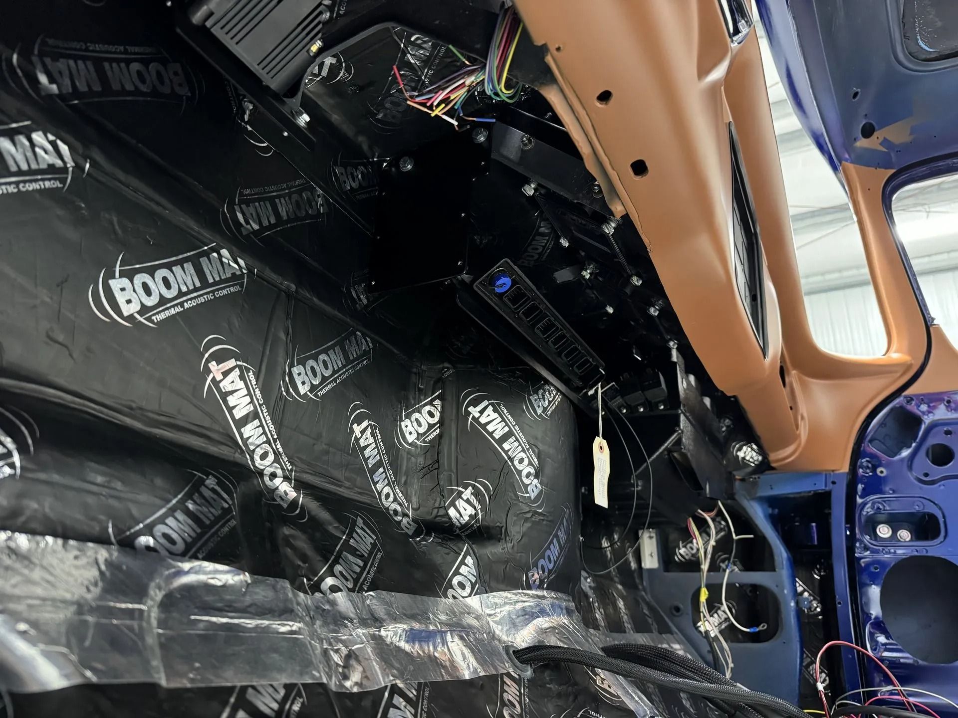 A car with a lot of electrical wires coming out of it.