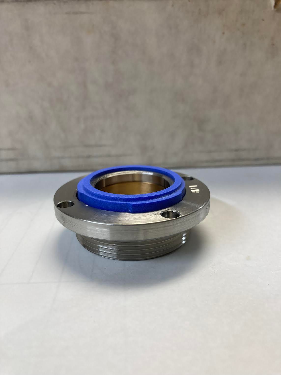 A stainless steel flange with a blue rubber seal on top of it.