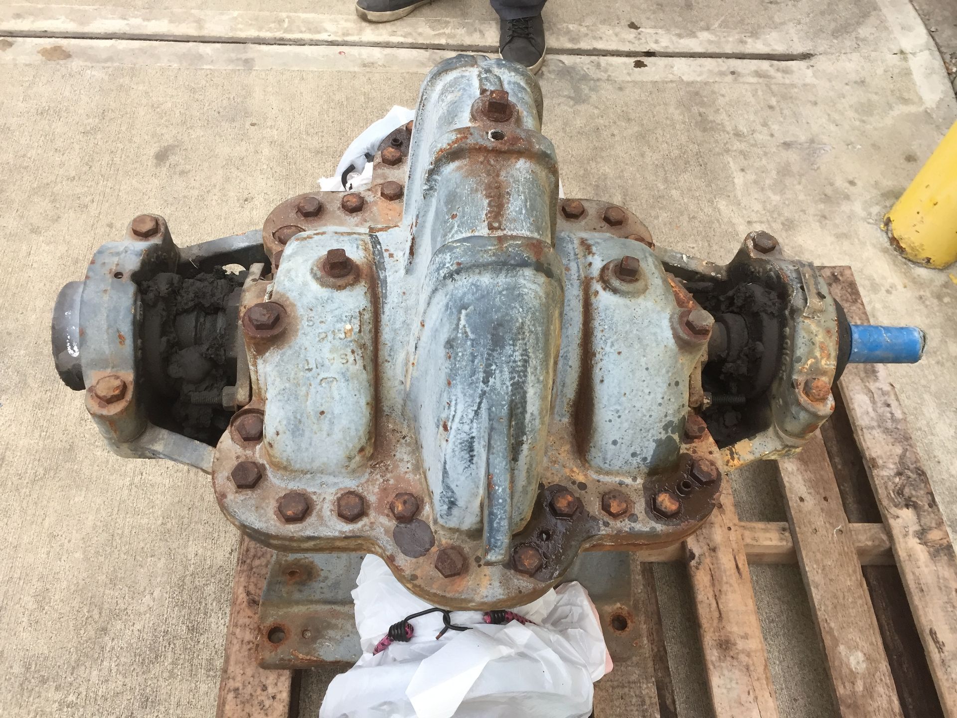 A large metal object is sitting on top of a wooden pallet.