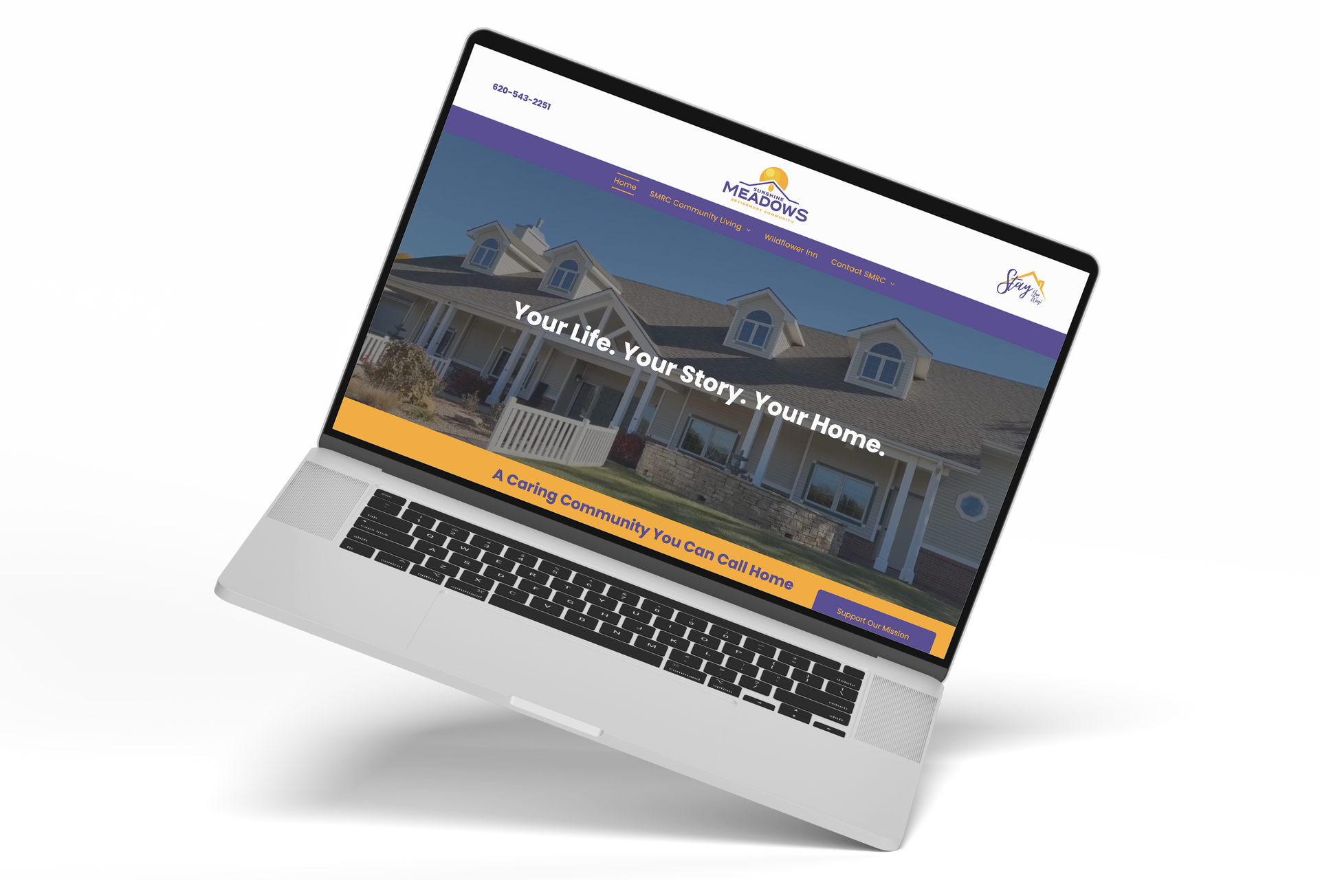 Laptop displaying a website with a home image and text: 