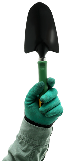 A person wearing green gloves is holding a shovel.