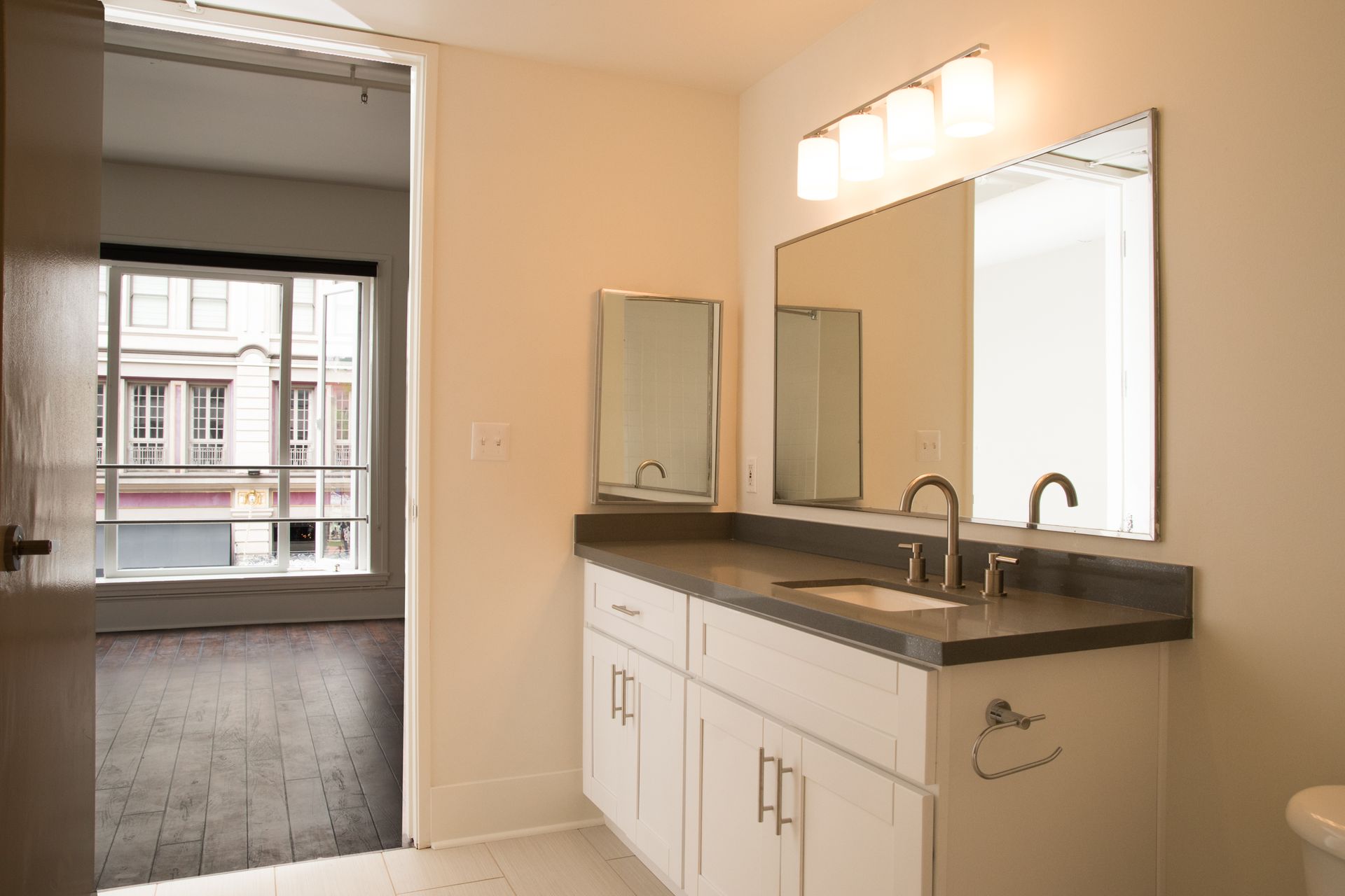 A bathroom with two sinks and two mirrors