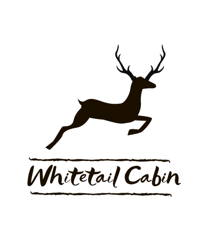 White deer logo above “Whitetail Cabin” in black on white background