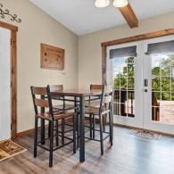 Dining area with a round table, high chairs, and French doors to a patio