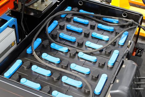 A close up of a blue and black battery on a forklift.