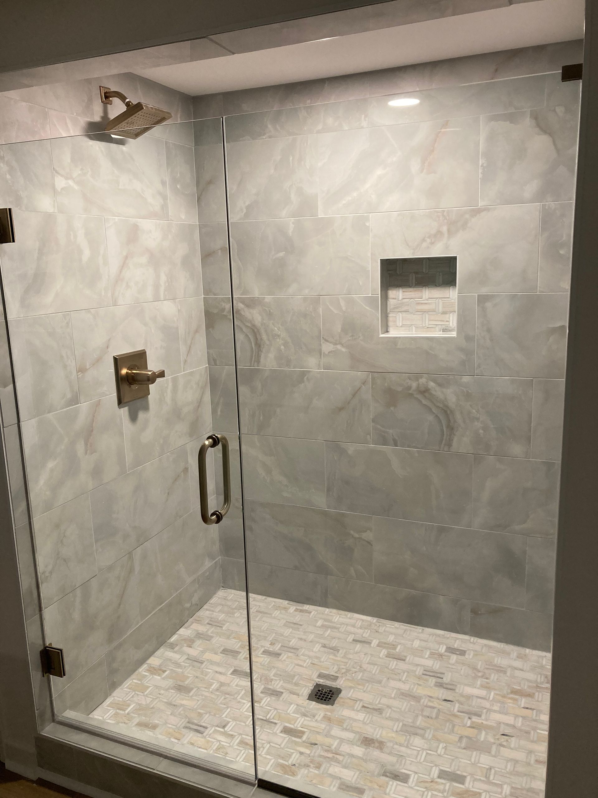 Construction site with a tall crane against a bright blue sky and white clouds.