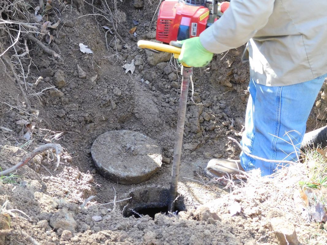 A man is digging a hole in the ground with a shovel.