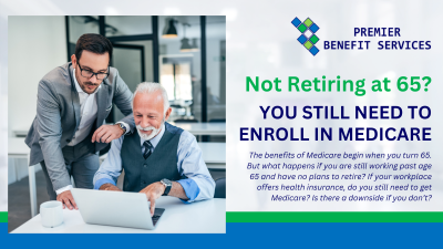 Two men are standing next to each other in front of a laptop computer.