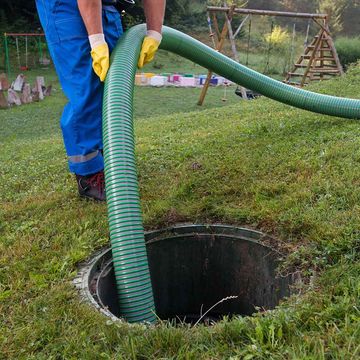 Septic Plumbing — Man Cleaning a Septic Tank in Hollywood, FL
