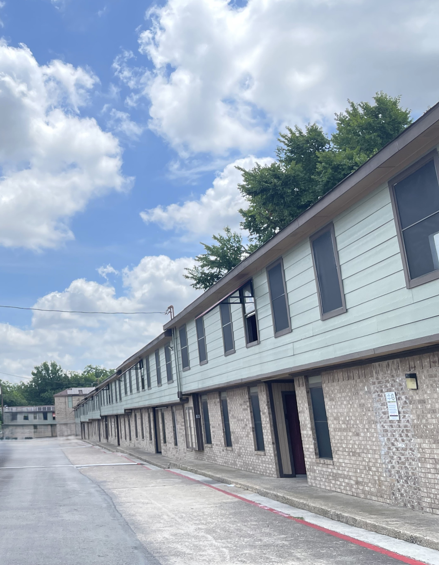 A row of apartment buildings with a blue sky in the background