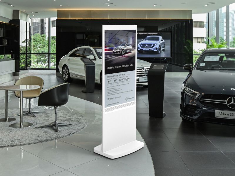 freestanding digital screen in a car showroom