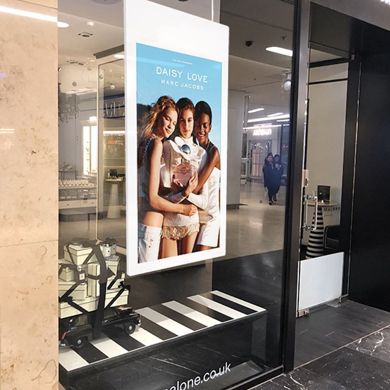 A window display for daisy love with a picture of three women